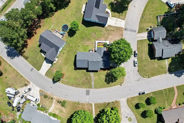 an aerial view of a house with a swimming pool
