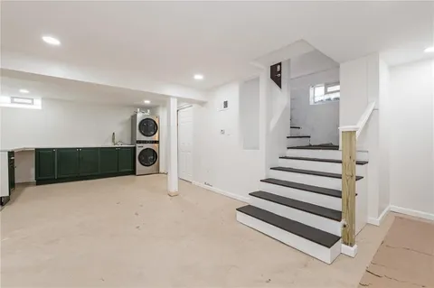 a view of a livingroom with entryway and stairs