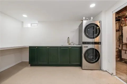a utility room with sink dryer and washer