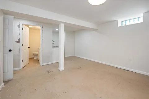 a view of a kitchen with white cabinets