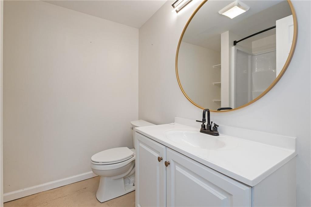 1516 Riverside Drive Verona, PA 15147 - Photo 31 of 38 a bathroom with a toilet a sink and a mirror