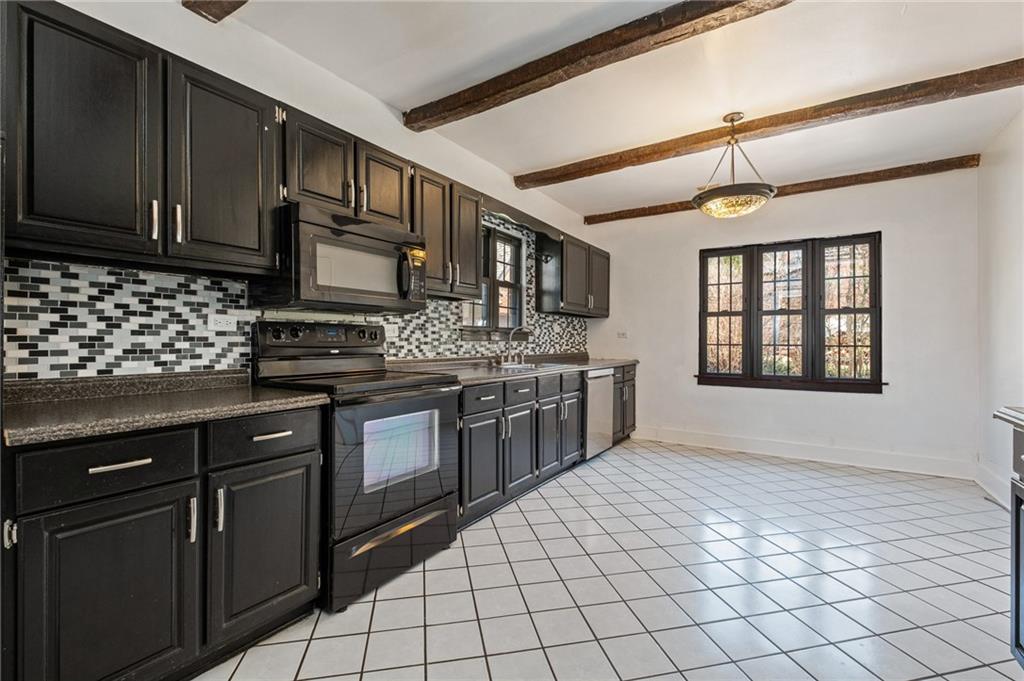 1516 Riverside Drive Verona, PA 15147 - Photo 6 of 38 a kitchen with stainless steel appliances granite countertop a stove sink and cabinets
