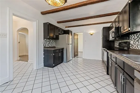 a kitchen with stainless steel appliances granite countertop a refrigerator and a stove