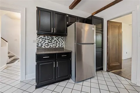 a white refrigerator freezer and a stove sitting inside of a kitchen