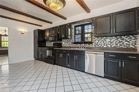 a kitchen with stainless steel appliances granite countertop a sink and cabinets