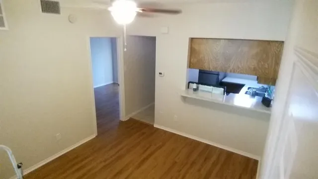 a view of kitchen and hallway with wooden floor