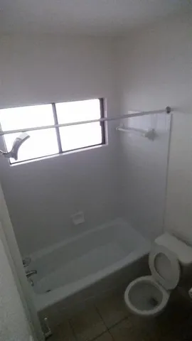 a bathroom with a shower and toilet