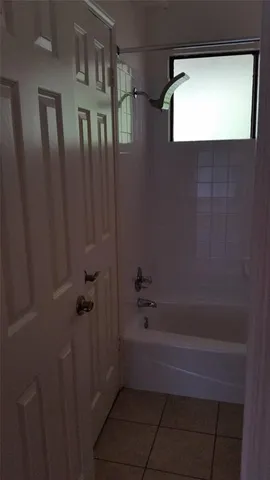 a bathroom with a shower and a tub