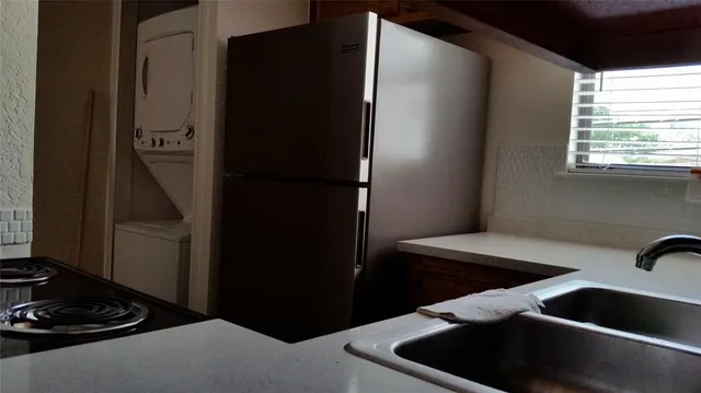 a kitchen with a refrigerator and a sink