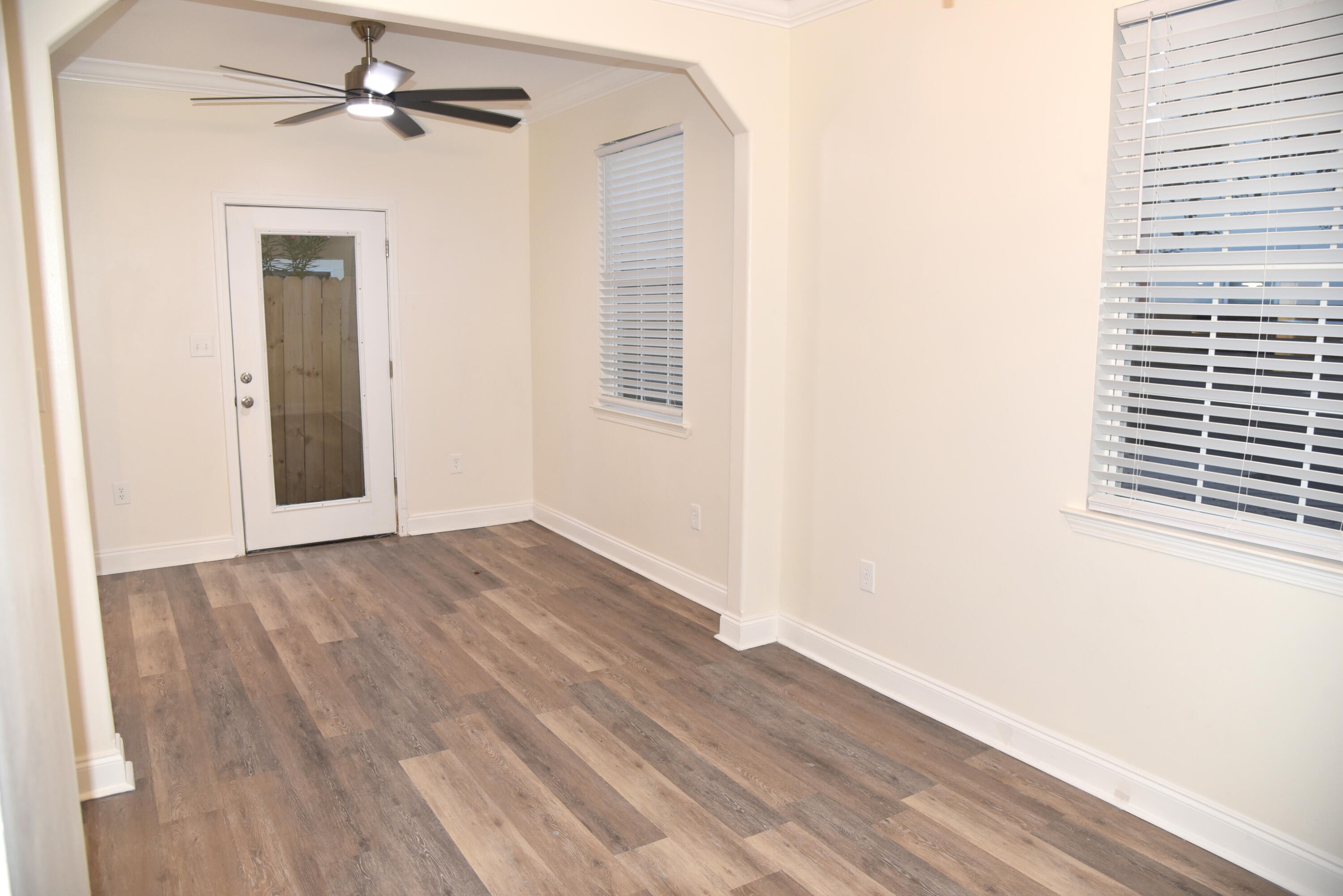149 Legion Park Loop Miramar Beach, FL 32550 - Photo 11 of 89 a view of a hallway with wooden floor and a ceiling fan
