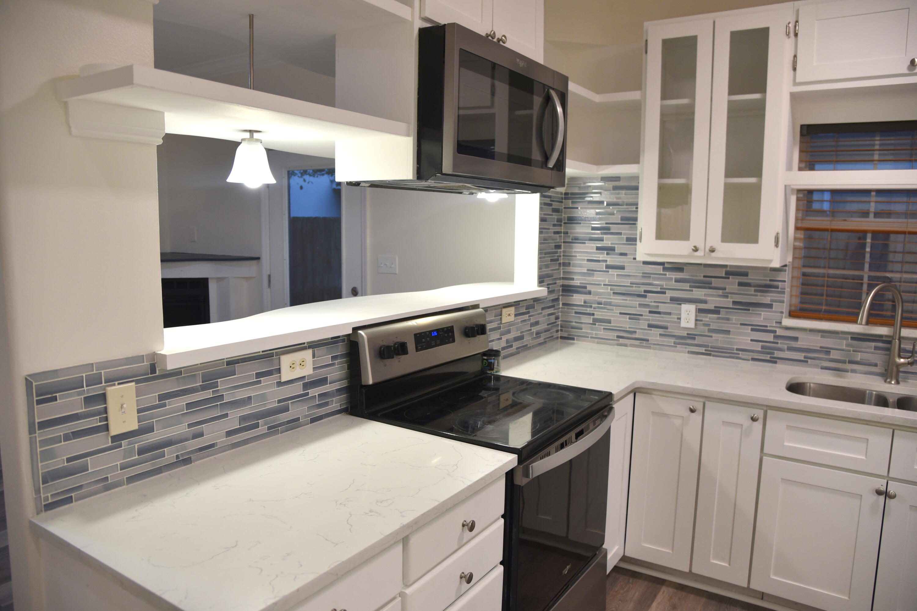 149 Legion Park Loop Miramar Beach, FL 32550 - Photo 30 of 89 a kitchen with stainless steel appliances granite countertop a sink and a stove