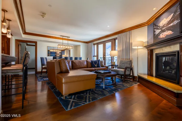 a living room with furniture a fireplace and a large window