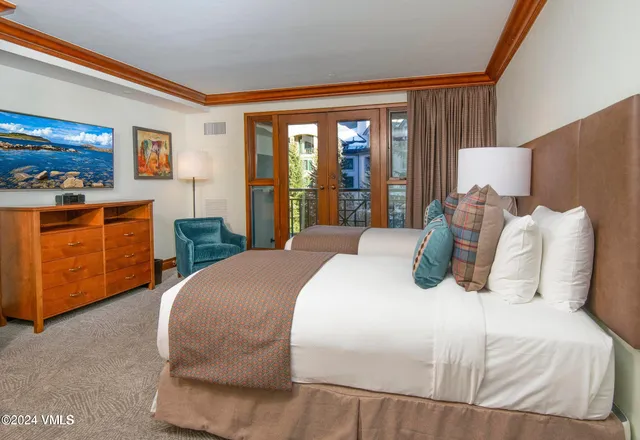 a bedroom with a large bed and a large window