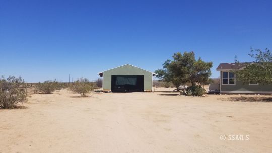 770 Alpine Way Ridgecrest, CA 93555 - Photo 5 of 50 a view of a house with a yard