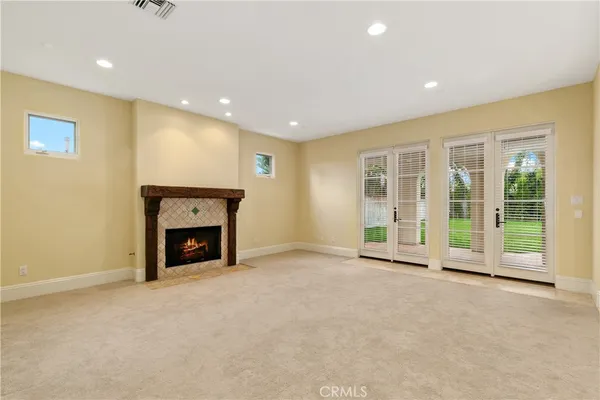 a view of an empty room with a fireplace