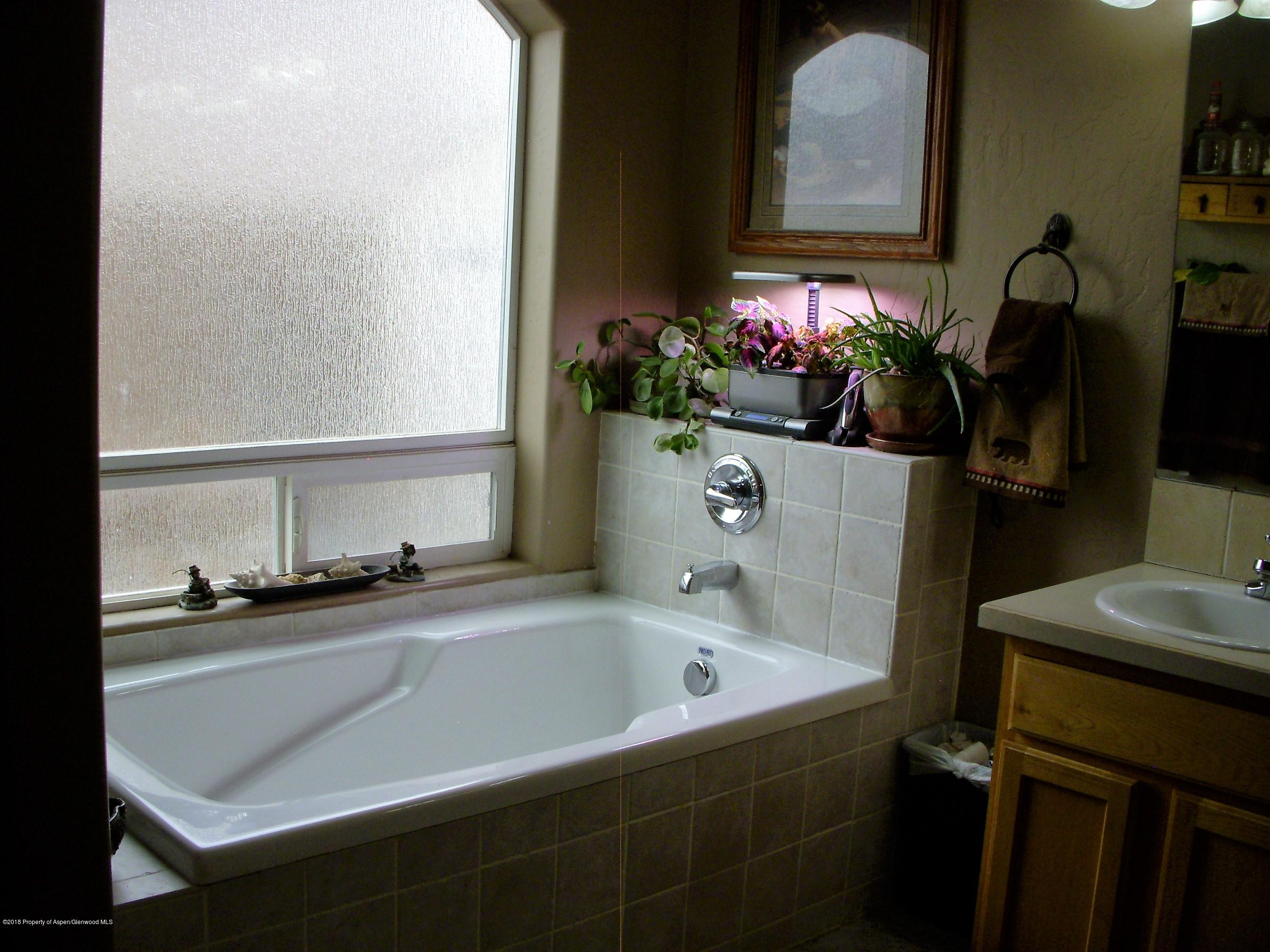 768 East 17th Street Rifle, CO 81650 - Photo 11 of 26 a bathroom with a sink and a mirror