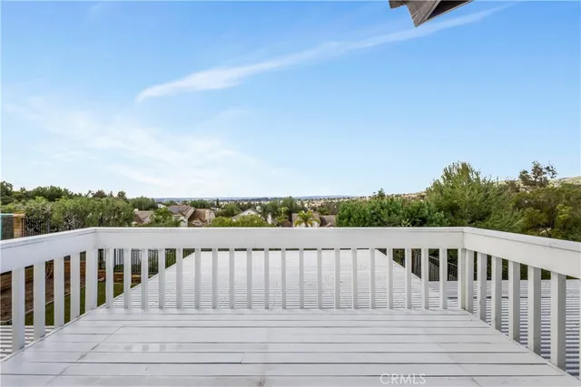 a balcony with wooden floor and fence