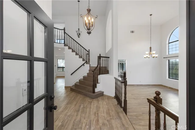 a view of an empty room with glass door and balcony