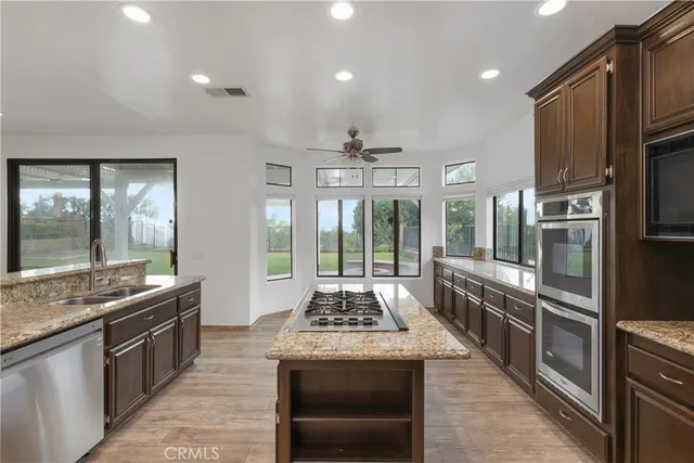 a view of empty room with wooden floor and fireplace