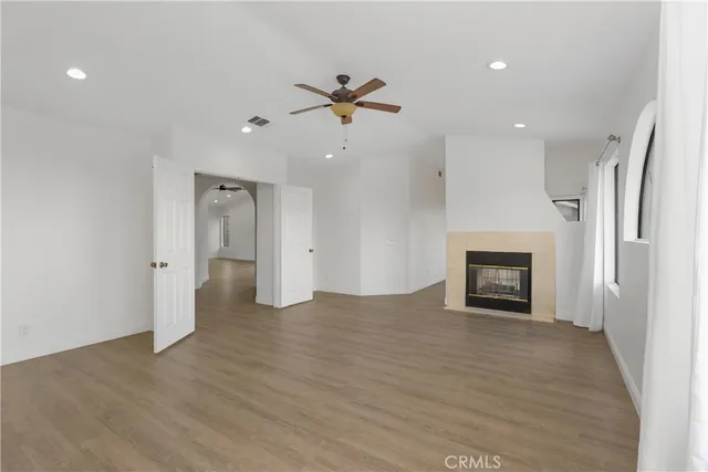 an empty room with a fireplace and fan