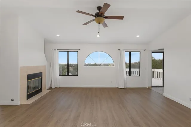 a spacious bathroom with a large tub shower and windows