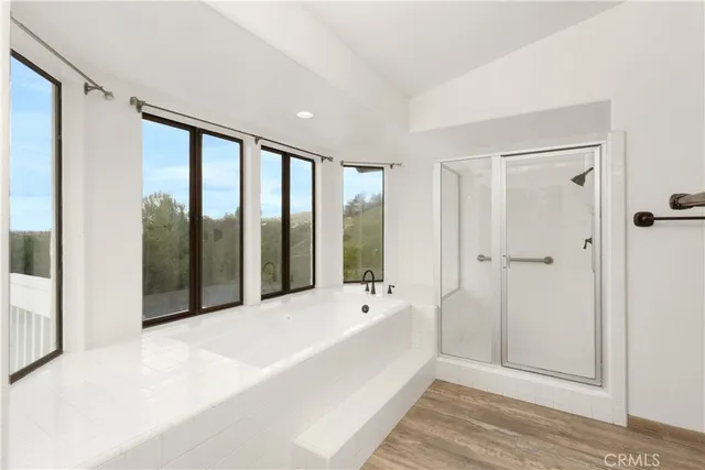 an empty room with a window and wooden floor