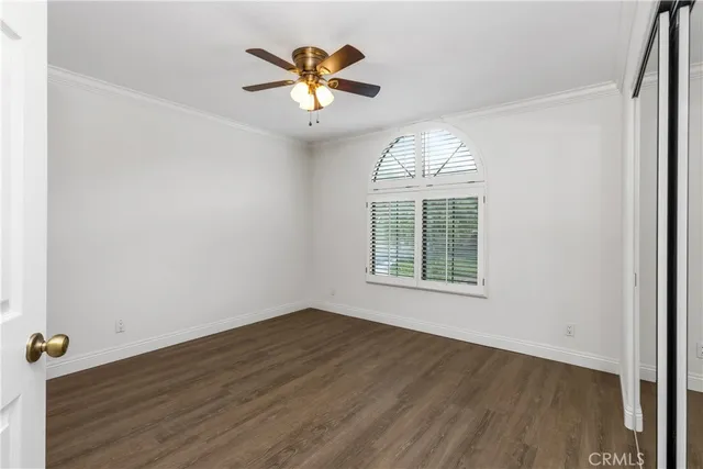 a front view of a house with a garden and yard