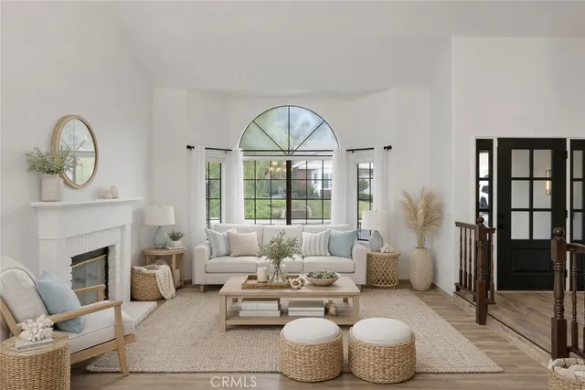 a living room with furniture a fireplace and a chandelier