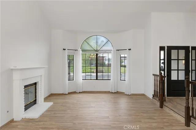 a view of an empty room with glass door and balcony
