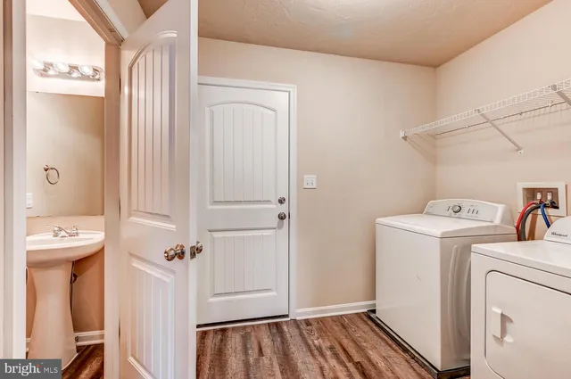 a view of a storage and utility room with a washer dryer