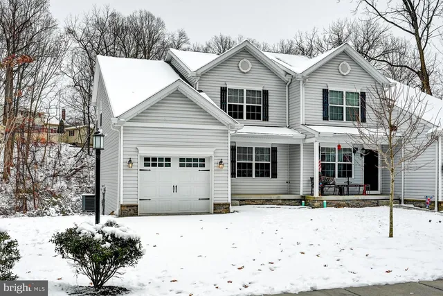 a view of a white house with large windows
