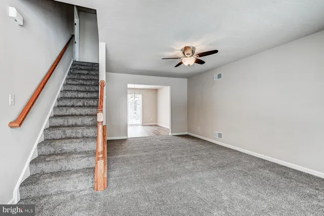 a view of an empty room with stairs