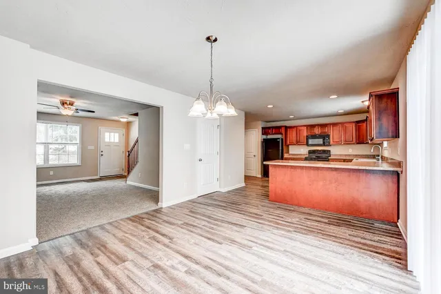 a view of a kitchen with granite countertop cabinets and refrigerator