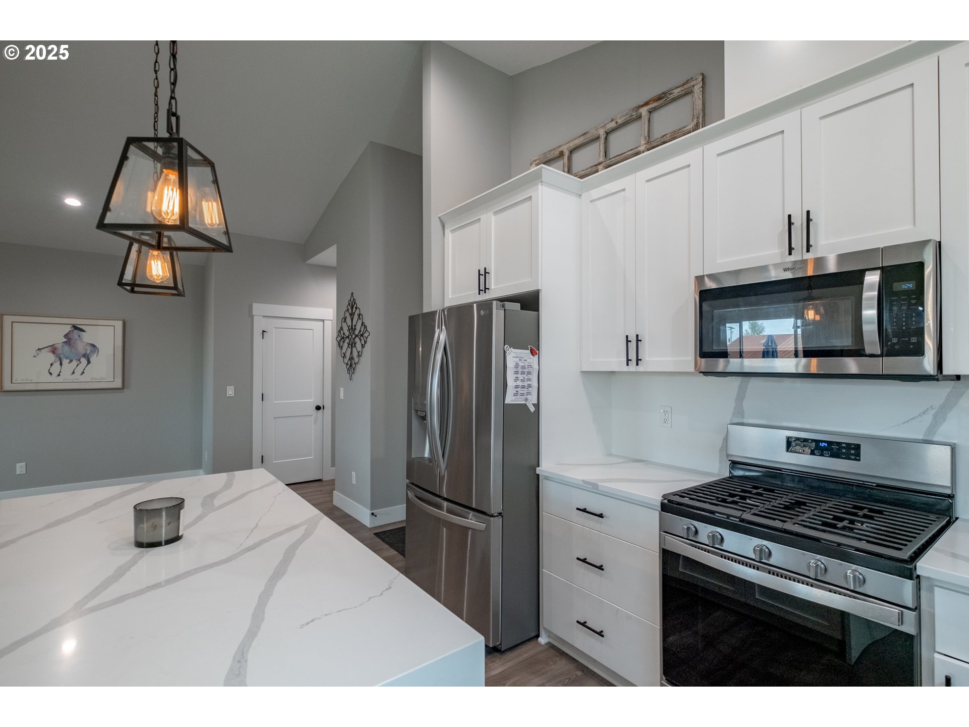 1006 Sassafras Street Independence, OR 97351 - Photo 16 of 47 a kitchen with stainless steel appliances granite countertop a stove a refrigerator and a microwave