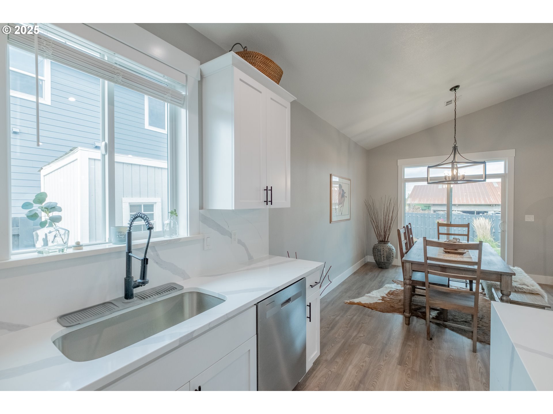 1006 Sassafras Street Independence, OR 97351 - Photo 17 of 47 a kitchen with a sink a counter top space and living room view