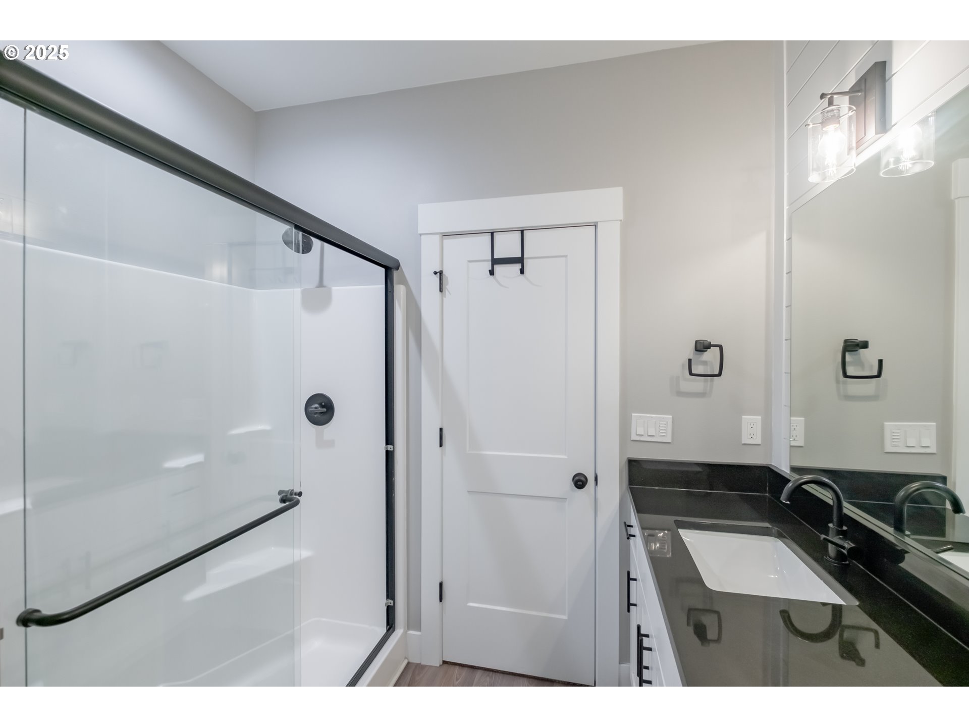 1006 Sassafras Street Independence, OR 97351 - Photo 30 of 47 a bathroom with a double vanity sink a mirror and a shower