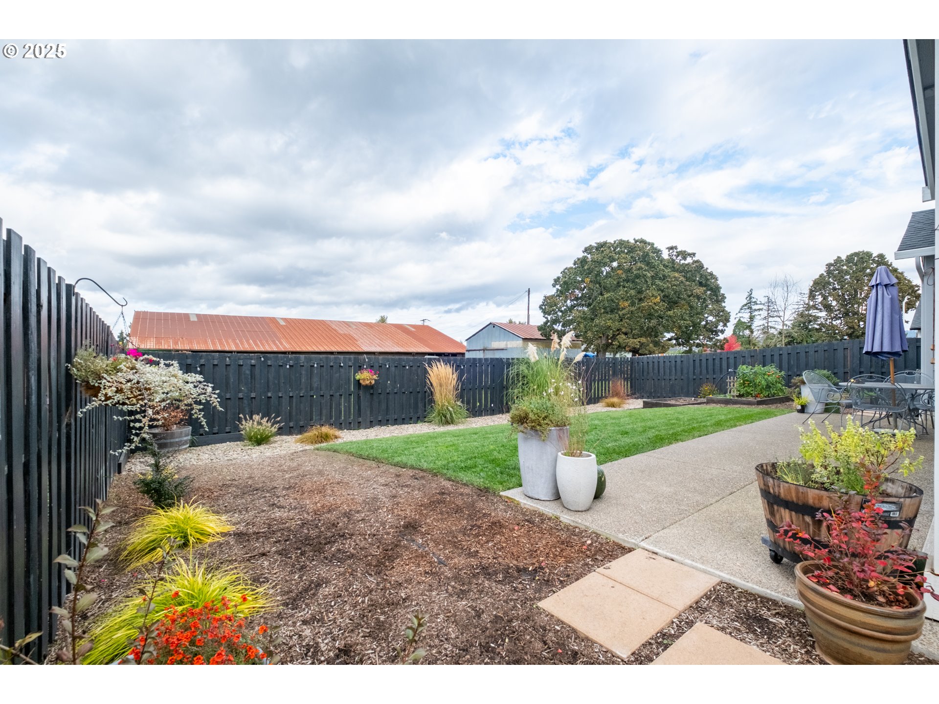 1006 Sassafras Street Independence, OR 97351 - Photo 37 of 47 a view of a garden with a building in the background