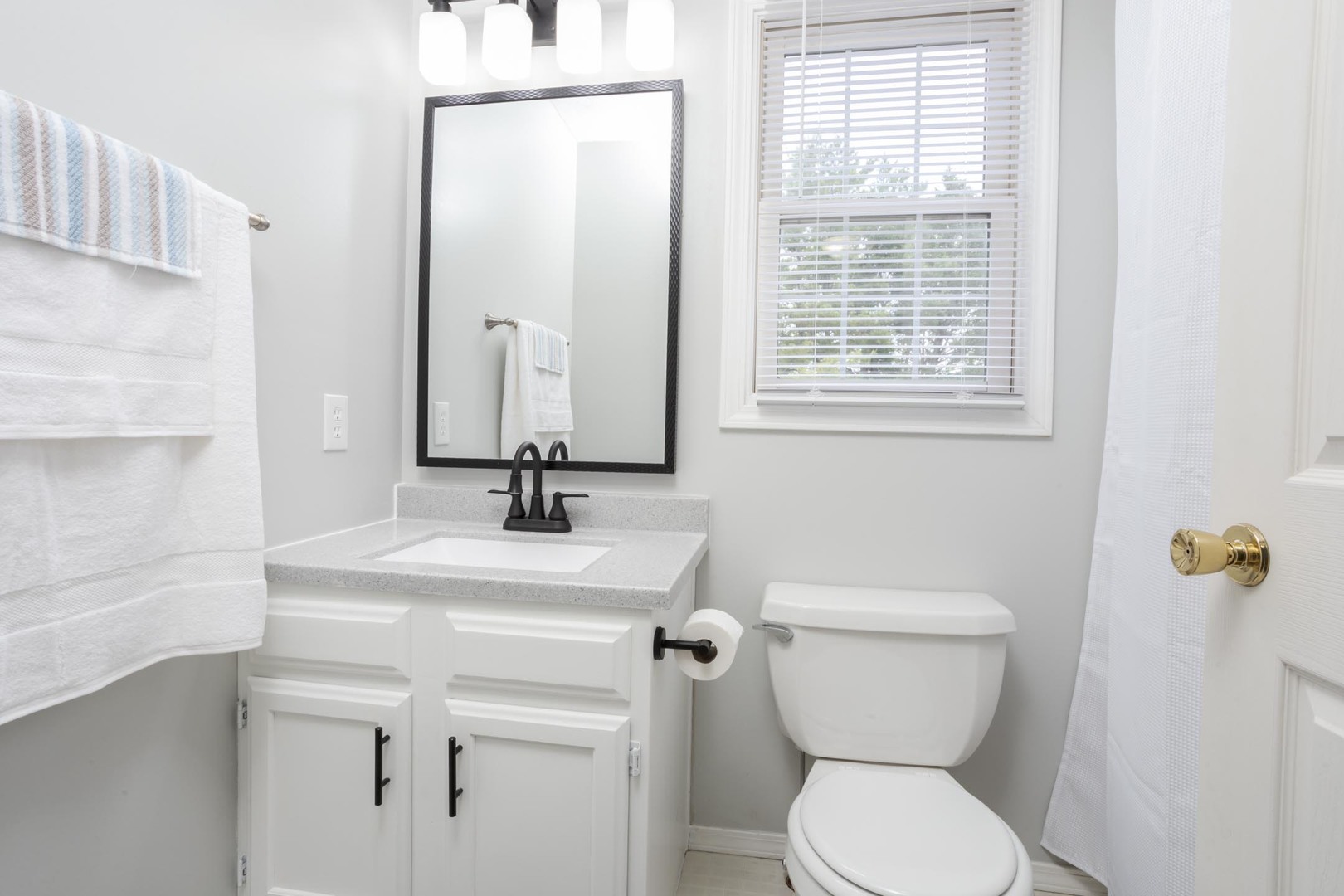 814 Landau Lane Normal, IL 61761 - Photo 40 of 58 a bathroom with a toilet sink and mirror