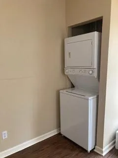 a kitchen with granite countertop a refrigerator a sink and wooden floors