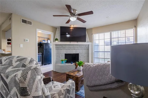 a living room with furniture a flat screen tv and a fireplace