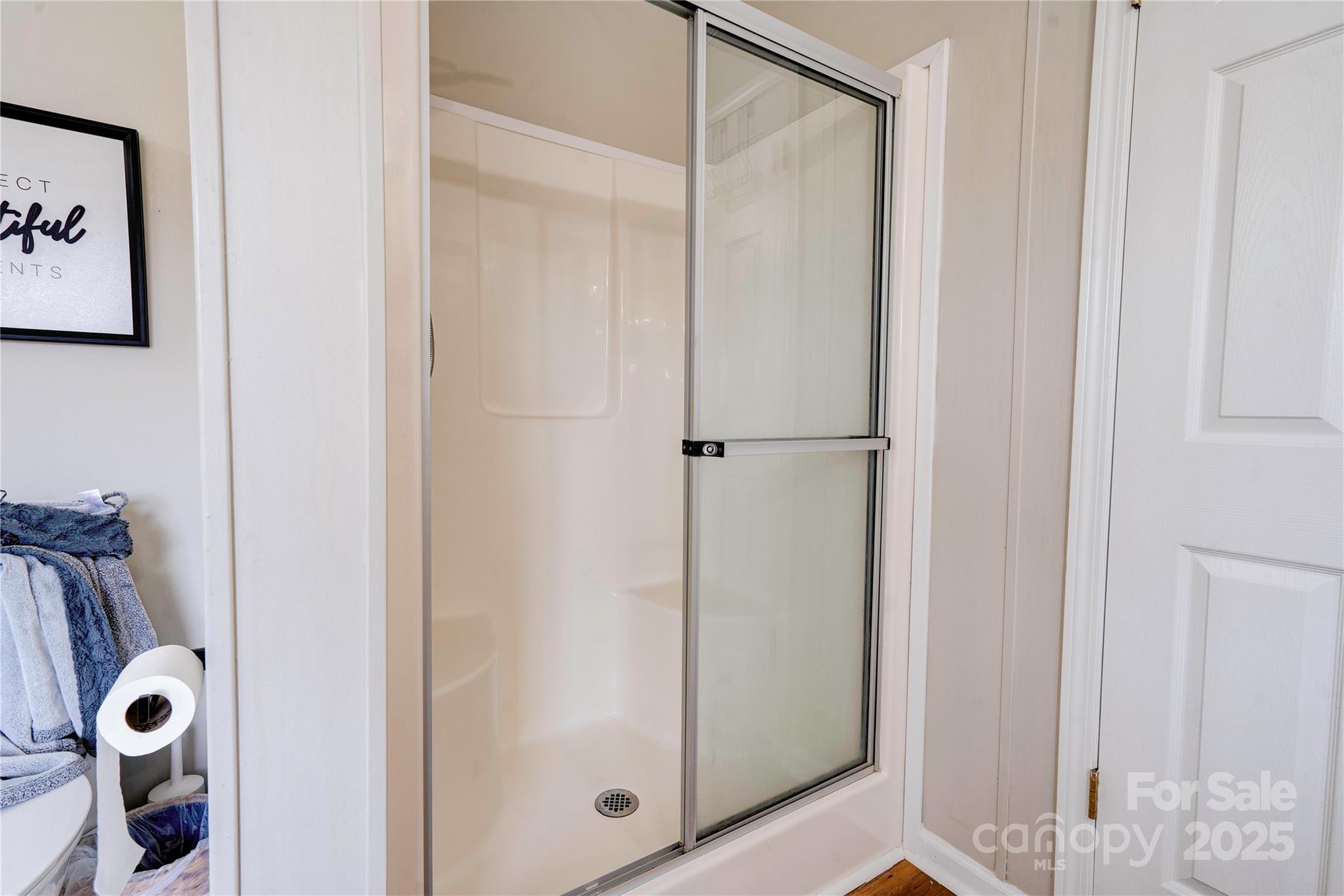 2002 Bachelor Road Mooresboro, NC 28114 - Photo 17 of 30 a bathroom with a glass shower door