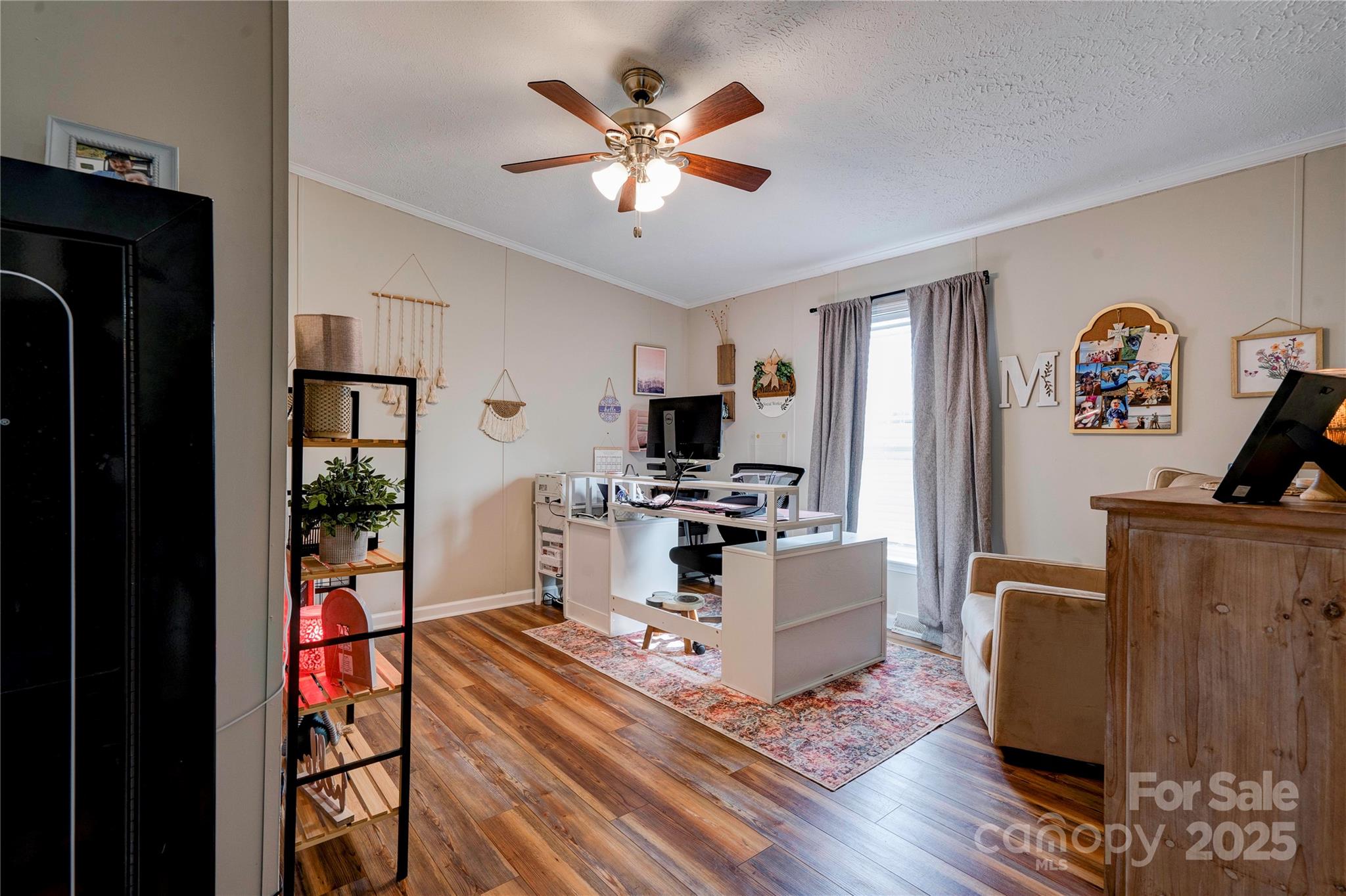2002 Bachelor Road Mooresboro, NC 28114 - Photo 21 of 30 a living room with furniture a flat screen tv and a fireplace
