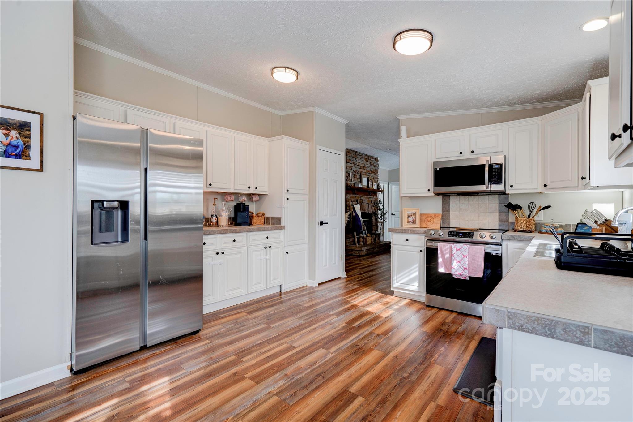 2002 Bachelor Road Mooresboro, NC 28114 - Photo 4 of 30 a kitchen with granite countertop a refrigerator stove and microwave