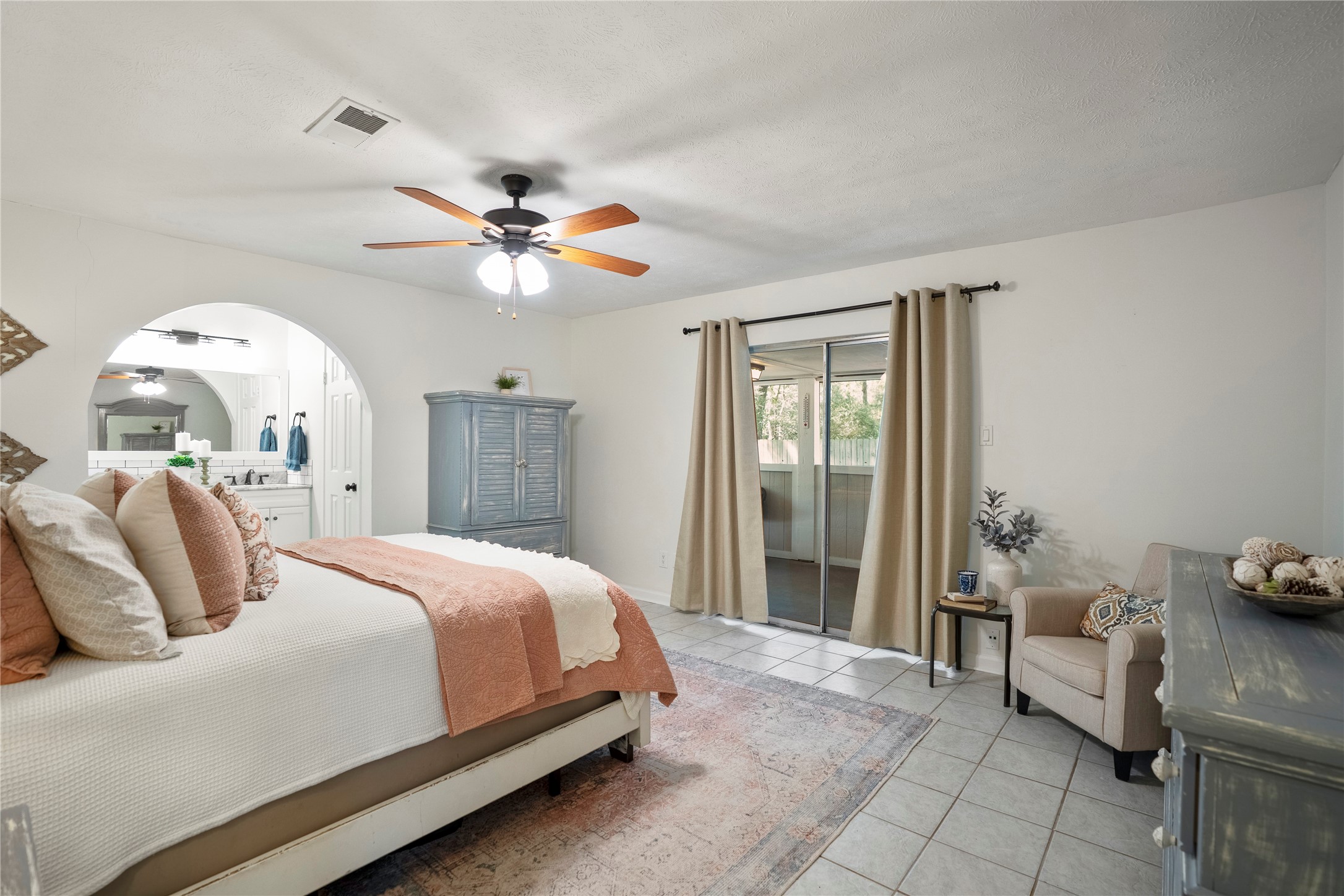 12224 Gun Oak Place Spring, TX 77380 - Photo 23 of 43 A spacious and serene bedroom offering flexibility for a sitting area or additional furnishings, with sliding doors providing direct access to the porch for a quiet indoor outdoor retreat.