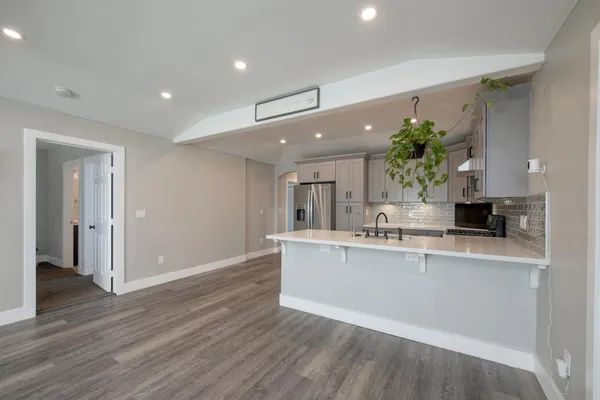 a view of living room with wooden floor and potted plant