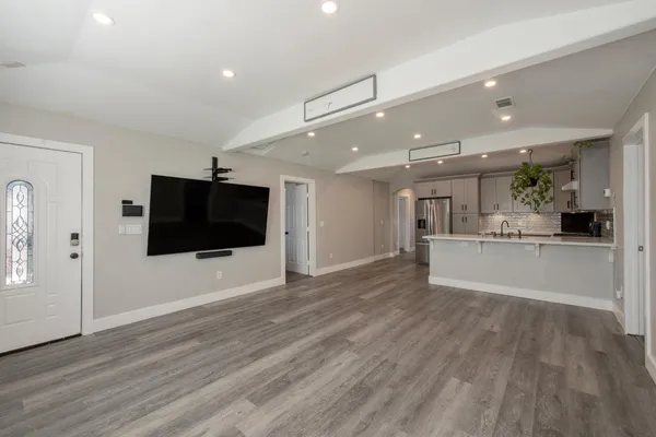 a view of a living room a flat screen tv and a kitchen