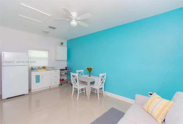 a dining room with a wooden table and chairs