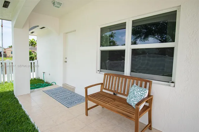 a view of bench in front of house