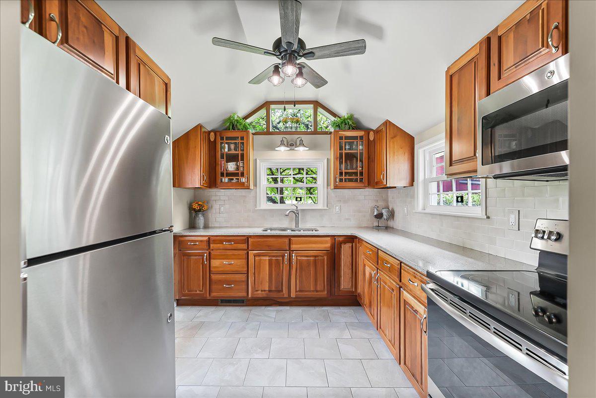 1439 Middletown Road Glen Mills, PA 19342 - Photo 11 of 45 a kitchen with stainless steel appliances granite countertop a refrigerator a oven a sink a stove and island