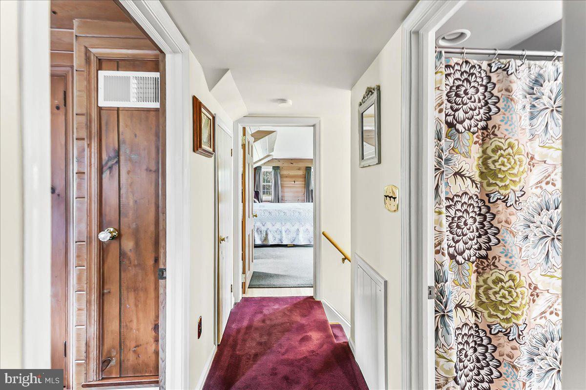 1439 Middletown Road Glen Mills, PA 19342 - Photo 29 of 45 a view of a hallway to a livingroom with wooden floor and a bathroom